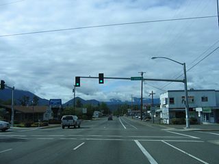 The succeeding traffic signal on SR 99 (6th Street) south is with Savage Street. Savage Street leads west to Hawthorne Avenue and east to Beacon Drive.