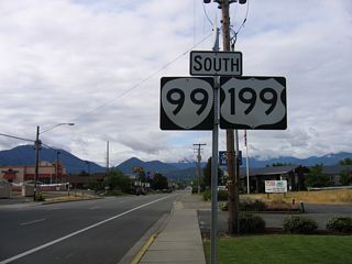 Posted south of where Vine Street (Historic U.S. 99) merges onto 6th Street, the U.S. 199 shield was removed from the replacement of this OR 99 sign assembly south of Vine Street by 2012.
