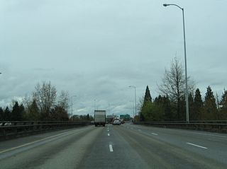 The ramp from OR 99/126 Business north (W 6th Avenue) joins I-105 / OR 126 over W 5th Avenue.