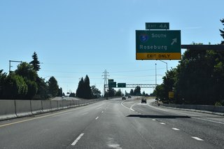 Entering the directional cloverleaf interchange with I-5 along I-105 east, Exit 4 A leaves for southbound to Goshen and Roseburg. I-5 lines both Eugene and Springfield on the ensuing stretch south across the Willamette River.
