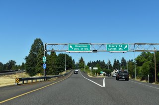 Ramps partition for direct access to Coburg Road south into Downtown and the University of Oregon and for local access to both north and south Coburg Road to Autzen Stadium. Heading south into Downtown, Coburg Road spans the Willamette River on the Ferry Street truss bridge toward OR 99 / OR 126 Business (E 6th / 8th Avenues).