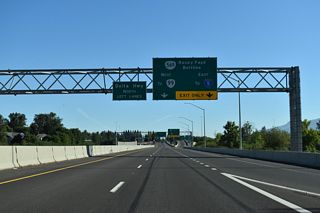 An auxiliary lane opens north from the Goodpasture Island Road entrance ramp to the distributor roadway for OR 569 (Beltline Highway). Originally a three quarter cloverleaf interchange joined the two state routes. The loop ramp from OR 569 east to Delta Highway north was eliminated.