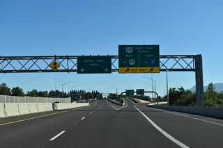 OR 132 ends at OR 569 while Delta Highway continues north as an at-grade boulevard west of Ayers Lake.