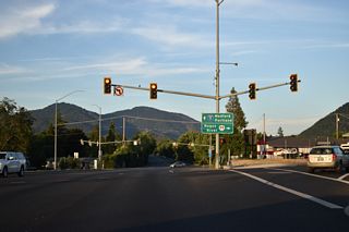 Intersecting U.S. 199 above the ramp from Redwood Highway to OR 99 northbound, OR 99 curves southeast onto Rogue River Highway from SW 6th Street. The former route of U.S. 99 travels east to Rogue River and Rock Point.