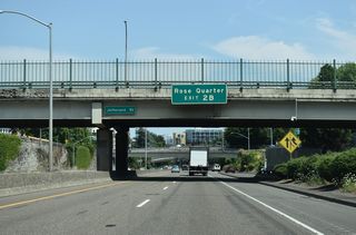 I-405 travels under SW Jefferson Street as the Stadium Freeway advances northeast to Exit 2 B for NW 14th Avenue to NW Everett Street. Located in the Lloyd District across the Willamette River, the Moda Center (Rose Quarter) is home to the Portland Trailblazers NBA team.