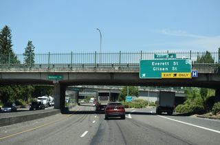Interstate 405 (Stadium Freeway) shifts north under W Burnside Street at Exit 2 B to NW 14th Avenue and NW Everett Street. NW 14th Street advances north through the Pearl District to NW 15th Avenue under the Fremont Bridge.