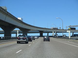 I-405 northbound follows the lower deck of the Fremont Bridge. The bridge and the north interchange with I-5 opened to traffic on November 15, 1973, which completed the 4.25 mile long urban loop ("Fremont Bridge (Portland, Oregon)", 2010).