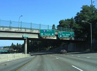 Traffic partitions into two lane ramps at the directional T interchange with Interstate 5. The left lanes of I-405 south default onto I-5 south for the capital city of Salem, Eugene, and eventually California.