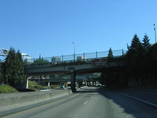 Interstate 405 travels below grade from the Couch Street overpass parallel to SW 14th Avenue east of the Goose Hollow neighborhood. West from Exit 1 D, U.S. 26 passes through the Vista Ridge Tunnels en route to Washington Park and the Oregon Zoo.