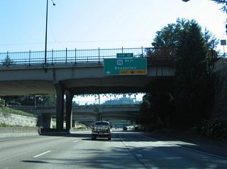 U.S. 26 (Sunset Highway) originally followed Naito Parkway north with OR 99W to the couplet of Market Street (east) and Clay Street (west) through the Portland city center. U.S. 26 was realigned onto Interstate 405 in 2005 (U.S. Route 26 in Oregon, 2025).