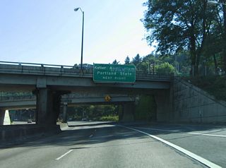 An entrance ramp provides access from Taylor Street and SW 13th Avenue onto Interstate 405 south at Montgomery Street. Forthcoming Exit 1C connects with SW 6th Avenue north to Portland State University and Keller Auditorium via Market Street east.
