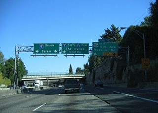 I-405 (Stadium Freeway) curves east from Exit 1 C and U.S. 26 to Interstate 5 at the Marquam Bridge. U.S. 26 spans the Willamette River along the Ross Island Bridge between Naito Parkway (OR 10) and Powell Boulevard.