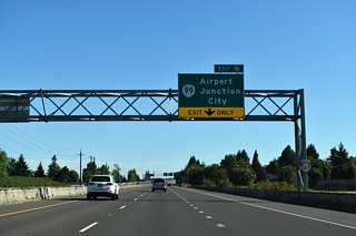 OR 569 advances north from Barger Drive to meet OR 99 at a folded diamond interchange next. OR 99 parallels the Southern Pacific Railroad line southeast to 6th / 7th Avenues west of Downtown Eugene.