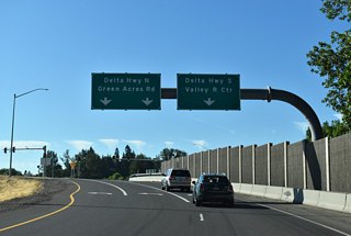 Turn lanes separate for Delta Highway north to Green Acres Road and Osprey Hollow Park and south for OR 132 to Valley River Center and Downtown Eugene.
