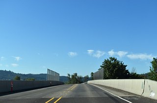 OR 569 downgrades into a two lane expressway south of the signalized intersection with Roosevelt Boulevard, crossing over Union Pacific rail lines en route to OR 126 (W 11th Avenue).