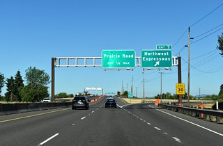 OR 569 enters the folded diamond interchange with Northwest Expressway at Exit 7. Northwest Expressway lines the western limits of River Road neighborhood southeast to Chambers Street.