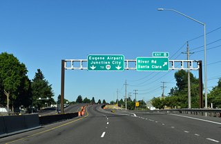 River Road heads 2.4 miles southeast to the junctions with Northwest Expressway and Roosevelt Boulevard. Chambers Street continues the road south to OR 99 (7th/6th Avenues). River Road continues 8.5 miles north of OR 569 to Junction City.