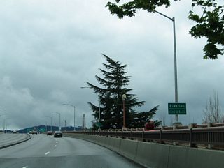 A small guide sign indicates that the next three exits serve downtown. The Coburg Road viaduct includes provisions for pedestrians and bicyclists.