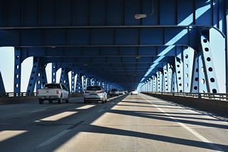 Built in 1973, the Girard Point Bridge totals 5,167 feet in length. The 96.1 foot wide decks accommodate three lanes with shoulders in each direction (Baughn, n.d.).