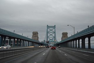 Pedestrian walkways line both sides of the Ben Franklin Bridge above the main travel lanes.