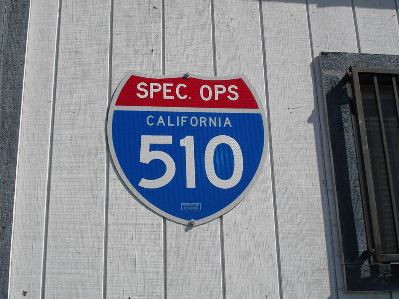 Sign on side of truck weigh station as seen from northbound Interstate 405 approaching Interstate 110/Harbor Freeway. For more on this, visit <a href="http://www.globalsecurity.org/military/agency/dod/socpac.htm">Special Operations Command Pacific (SOCPAC) - Joint Task Force 510</a>.