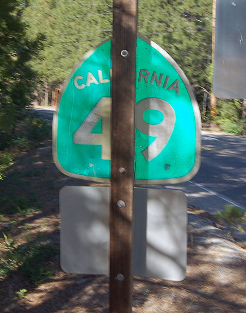 Recycled state route shield serving as a trailblazer to a Caltrans maintenance depot.