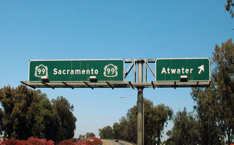 Poorly covered up US-99 shields on this freeway guide sign.