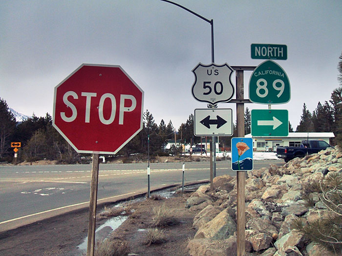 State route, US route, and scenic highway markers on gantry near Lake Tahoe.