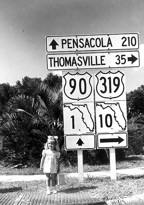 Carolyn Rae Sandgren, and a variety of Florida route markers, circa 1948 or 1949.<br><br>
The 24" white squares were used at intersections (as mandated by the 1948 MUTCD), and the 16" shields (cutout US and square state road) were reassurance markers. The state road numbers are from the pre-1945 numbering: the Great Renumbering of 1945 took several years to implement in the field, and new shields were made with the old numbers. The cutout US-90 is a remnant with square fonts, and the other shields - and the two guide signs - use new round fonts, also mandated by the 1948 MUTCD.<br><br>