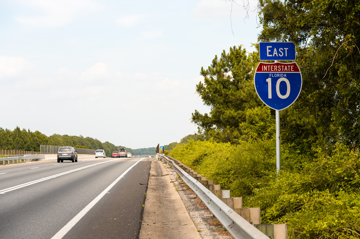 State named Interstate 10 shield posted on the mainline east of U.S. 301 (Exit 343).