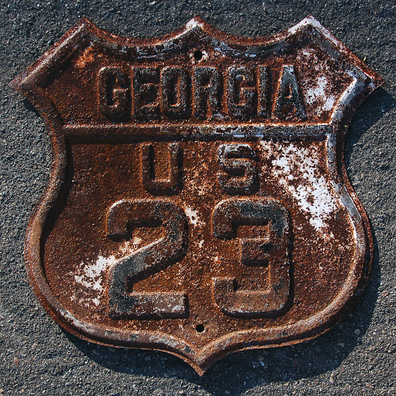 This shield was taken down, retrofitted to 1930s specifications with a layer of glass-bead reflective foreground, and put back up, in 1959.