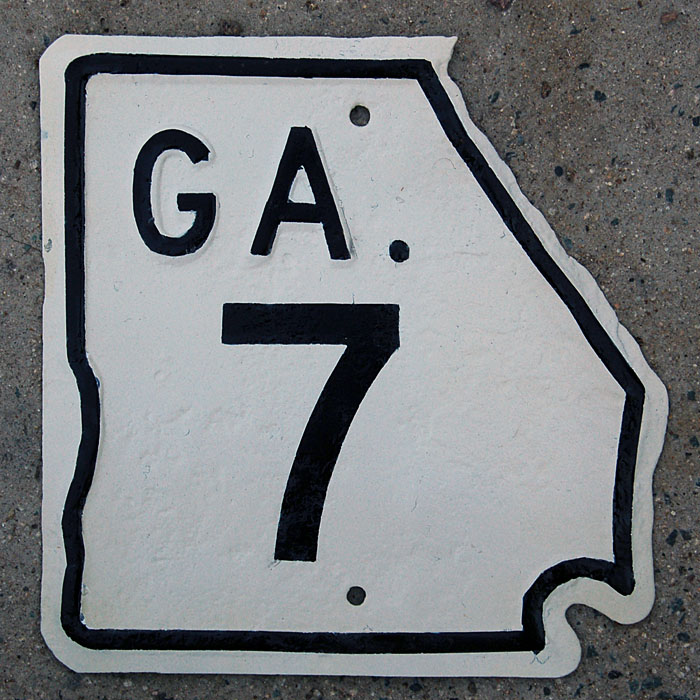This sign has been restored to its original retroreflective white background and non-reflective black foreground.