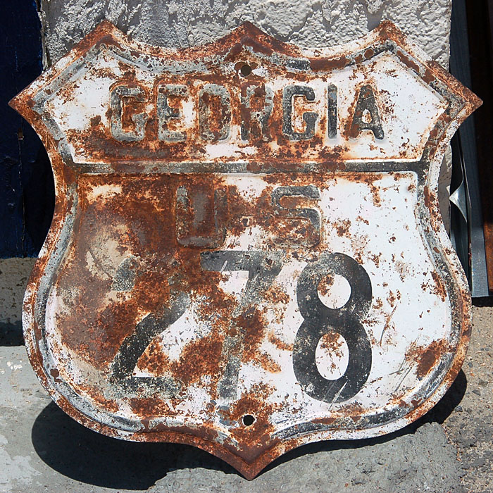 An older blank, with newer font style.  This sign was stamped out in the 1940s, and printed in 1959.