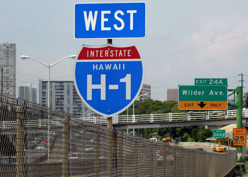 Westbound Interstate H-1 approaching Exit 24B, Wilder Avenue - there is no right shoulder along this section of Interstate H-1. Someone must have hit the shield and deflected it over the years. First