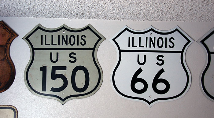 The 150 is a genuine shield.  The 66 is a replica, issued by the Illinois highway department in 1975 when the route was decommissioned.  These replicas were all non-reflective.