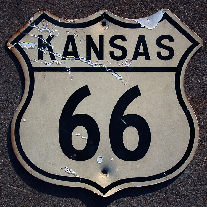 The genuine article.  Note square mounting holes, rounded corners, distinct Kansas-style digits.