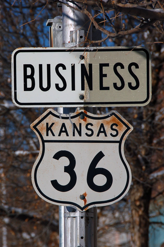 Business route cutout shield with state name.