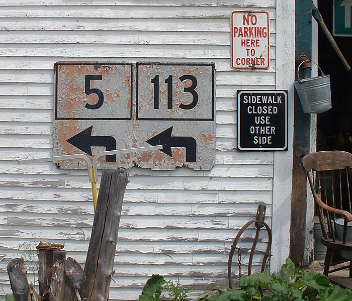 Old one-piece sign on the side of a barn.