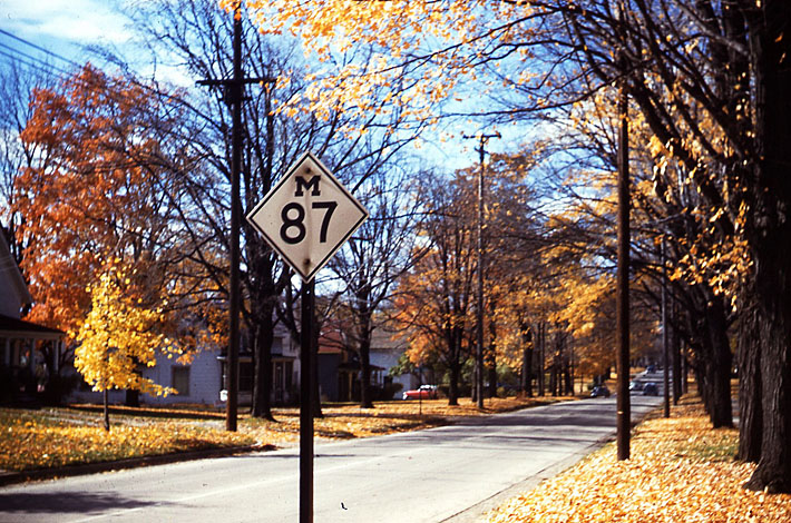 Fenton.  <br><br>

<i>Before my dad passed on his 35mm Argus C3 Camera to me, he let me take it out one day in November of 1956.  I stumbled on this photo that I took right here in Fenton 53 years ago.  As I think about it, it was my first intentional highway sign photo!  M-87 was decommissioned the following year.  It ended about a half mile down the street here at the Junction with US 23.  In 1957, the first stretch of US 23 freeway was opened from Fenton to Clio, Michigan; when US 23 was shifted, they took out M-87 at the same time.</i>