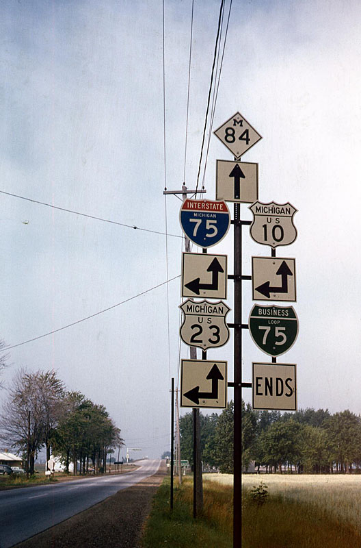 Bay City. <br><br>
<i>This sign assembly had virtually every basic Michigan route on it, so I stopped and snapped the photo. This is I-75 Exit 160. US 10 now begins two miles north at Exit 162. I-75 and US 23 are still together, and M-84 is unchanged. The I-75 Business Loop is gone.</i>