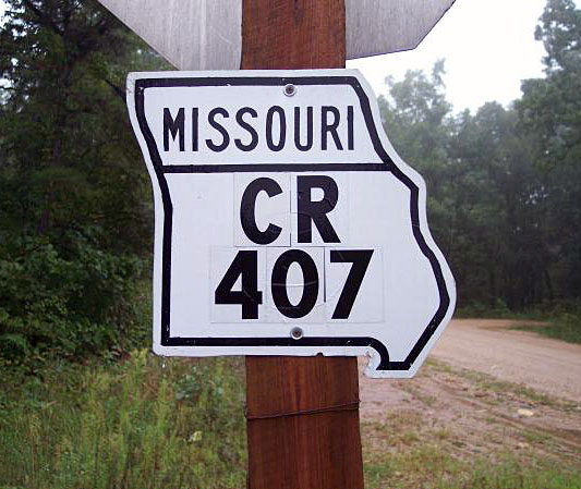 1940s highway marker, reused by the county.