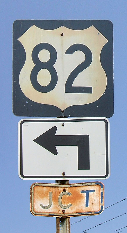 1960s steel US-82 shield, and even older embossed JCT banner.  When first put up, this gantry had the JCT banner and a 16" or 21" cutout US-82 shield.  The cutout 82 was replaced by the 82 shield shown here, and when the bypass was built, the arrow was added, and the JCT plate moved around, even though it was technically rendered incorrect.