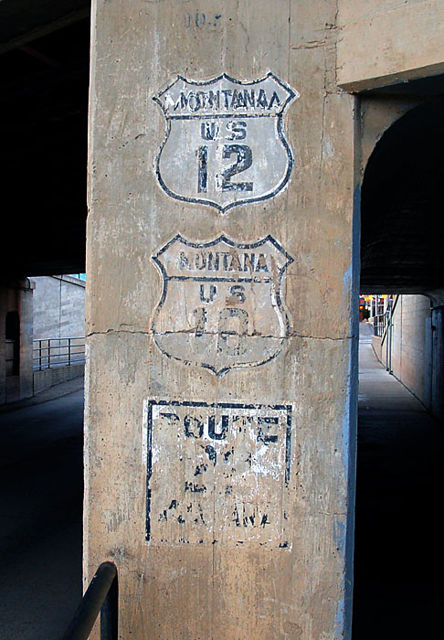Old shields painted on the side of a late 1930s underpass.