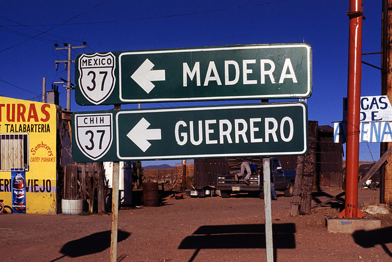 Chih. 37 to Madera and Guerrero. There is a shield error, and Chih. 37 is the safe bet as to the correct designation because Mex. 37 would be out-of-zone at this location. The village at the intersection is named "La Junta" on some maps and "Adolfo López Mateos" on others.
