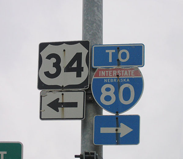 An Interstate 80 shield and a U.S. 34 shield are posted on a traffic signal along southbound 9th Street at O Street in downtown Lincoln. Use O Street east to continue on U.S. 34, or turn right to follow O Street to U.S. 6, Nebraska 2, and Interstate 80.