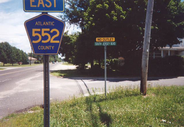 Atlantic County 552 (Cumberland Avenue) eastbound reassurance shield posted at the South Jersey Boulevard intersection in Milmay. Atlantic County 552 provides the through route between Bridgeton, Millville, and Vineland eastward to Mays Landing and the U.S. 40 corridor into Atlantic City.