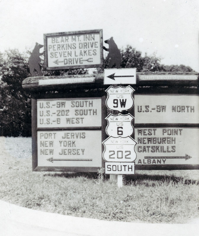 1940s photo of cateyed shields and guide signs.