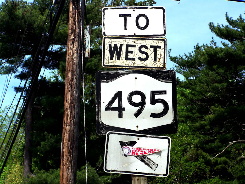 This trailblazer sign for the Long island Expressway dates to when it was still signed as New York Route 495. It had not been removed or changed since 1983 when the Expressway became an Interstate. The sign appears to be hand painted.