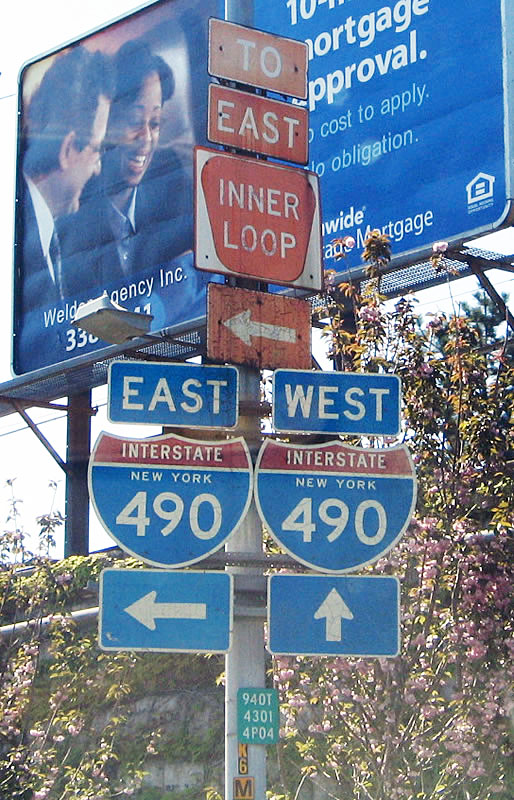 Inner Loop and Interstate 490 New York trailblazers posted on Central Avenue. Central Avenue squeezes between the Inner Loop and a CSX Railroad line.