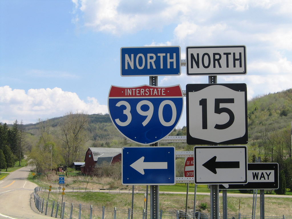 Interstate 390 & New York 15 shield assemblies posted at the Michigan Hollow Road diamond interchange (Exit 1) near Avoca.